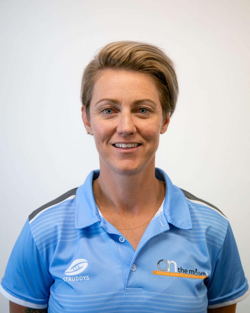 Nic Grose in a blue polo posing for a photo.