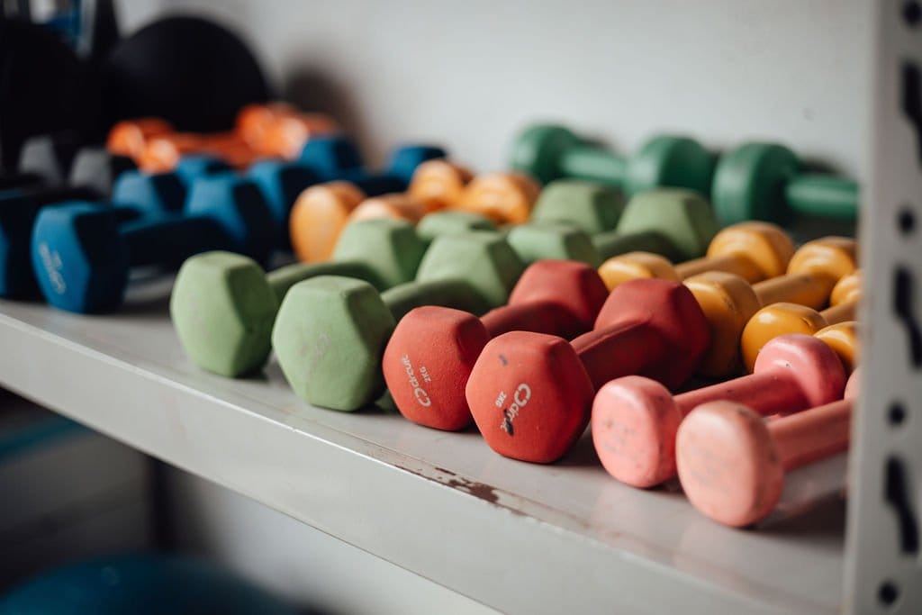 Colourful dumbbells on a shelf in a disability rehabilitation centre.