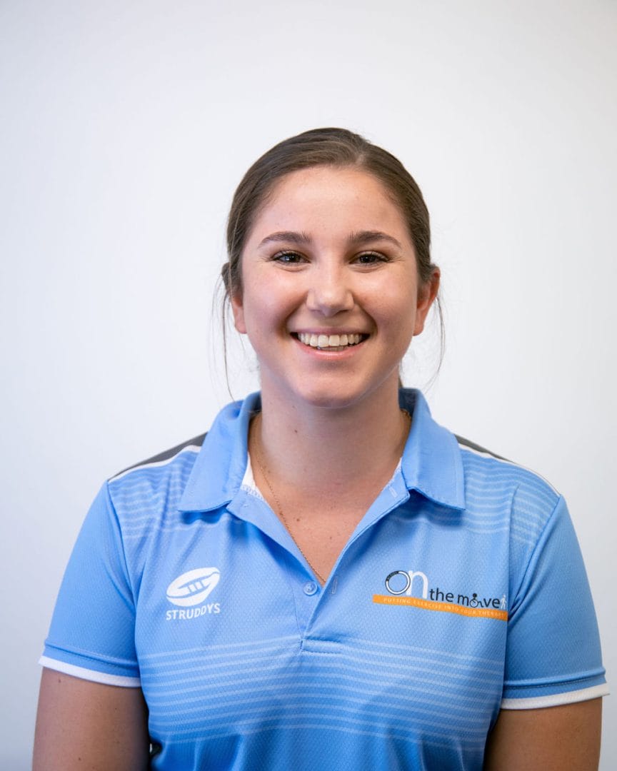Emma Schmidt in a blue polo shirt smiling.